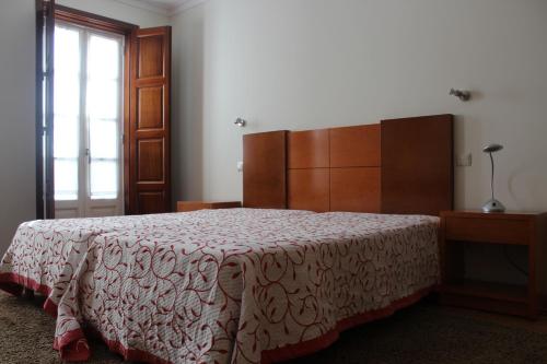 蒙考穆拉拉斯杜米诺旅馆的一间卧室配有一张床、一个梳妆台和一扇窗户。
