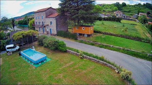 Saint-Genest-de-BauzonROULOTTE DE CHARME的享有庭院内一座带游泳池的房屋的空中景致