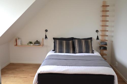 隆德Forskarhotellet的一间卧室配有一张带黑白枕头的床