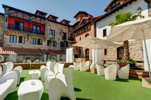 苏安塞斯哥斯达黎加埃斯梅拉达套房酒店的庭院里一排白色的椅子和遮阳伞