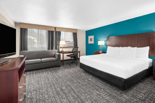 波特兰波特兰西北拉奎塔酒店及套房的酒店客房配有一张床、一张沙发和一张书桌。