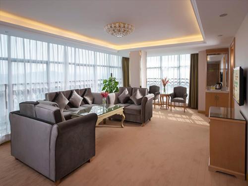 广州维也纳酒店广州番禺大石桥店的带沙发和桌子的大客厅
