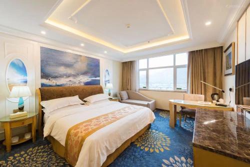 西宁维也纳国际酒店青海西宁天峻桥店的酒店客房设有一张大床和一张书桌。