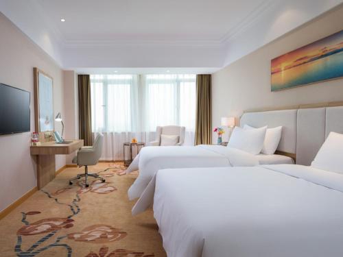 Wanzhi维也纳3好酒店(芜湖县汽车站店)的酒店客房设有两张床和电视。