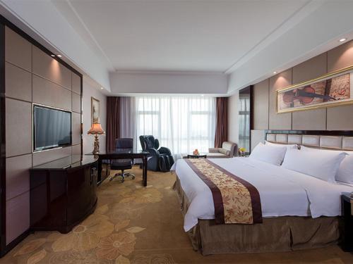 中山维也纳国际酒店广东中山北站店的酒店客房设有一张大床和一台电视。