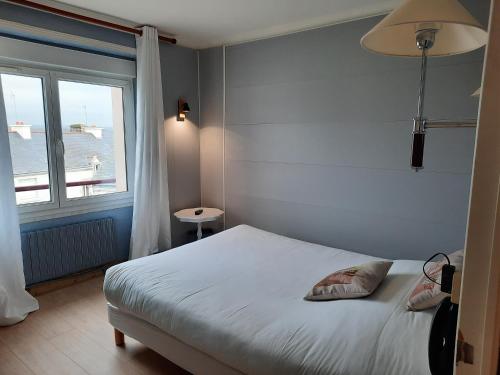 塞科斯Hôtel des îles的一间卧室设有一张床和一个大窗户