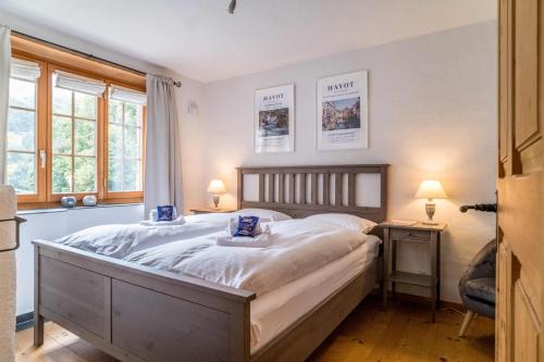劳特布龙嫩Apartment Rybibach Retreat的一间卧室设有一张大床和两个窗户。
