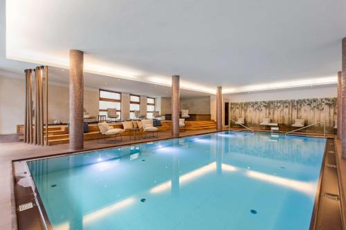 科尔蒂纳丹佩佐Grand Hotel Savoia Cortina d'Ampezzo, A Radisson Collection Hotel的在酒店房间的一个大型游泳池