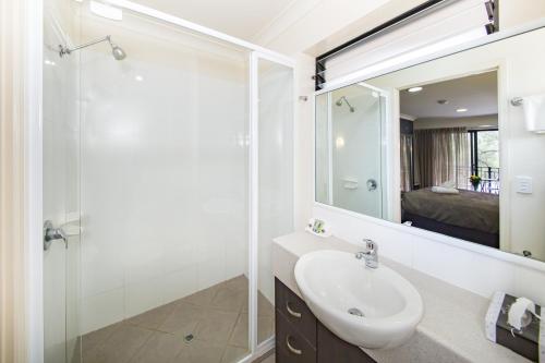 多尔比多尔比航道汽车旅馆的白色的浴室设有水槽和淋浴。