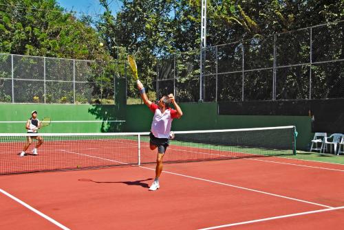 Paraíso古阿卡玛雅山林小屋的在网球场打网球的人