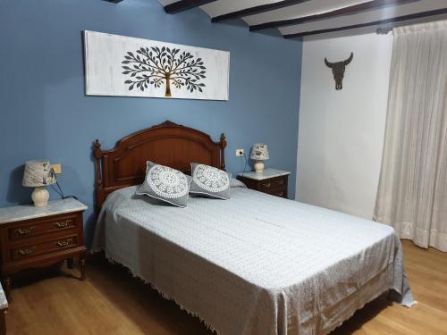 塞戈尔韦Casa Castillo de la Estrella的一间卧室设有一张床和蓝色的墙壁