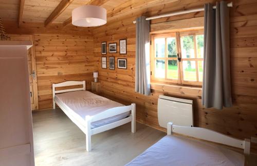 Tourville-la-ChapelleLe Chalet Caux-Marin的小木屋设有床和窗户
