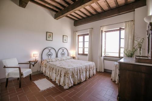 Isola d'AstiAgriturismo Bricco San Giovanni的一间卧室配有一张床、一张桌子和一个窗户。