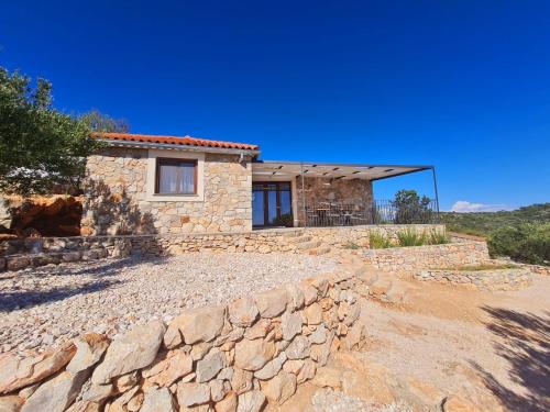 萨利Luxury stone house in a Nature park的石头房子前面有石墙