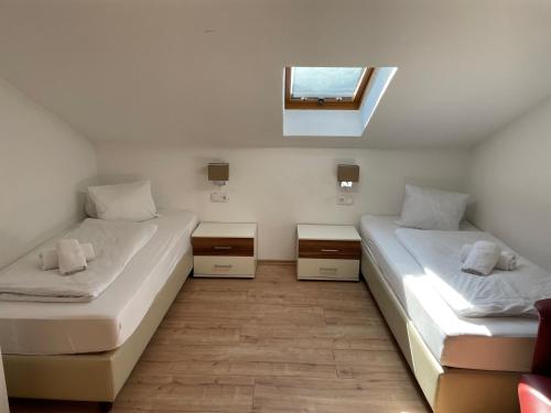 尼德恩西尔Apartments Garden House的小型客房 - 带2张床和窗户