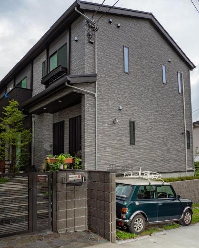 镰仓市Kamakura International House Japanese-style room w Shower Toilette - Vacation STAY 11585的停在房子前面的绿色汽车