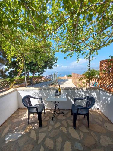 KoumeikaBeautiful house located on a hill in Samos Island, 400 m from an organized beach的海景露台配有桌椅