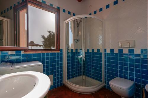 卡皮塔纳Cedri 14的蓝色瓷砖浴室配有淋浴和盥洗盆