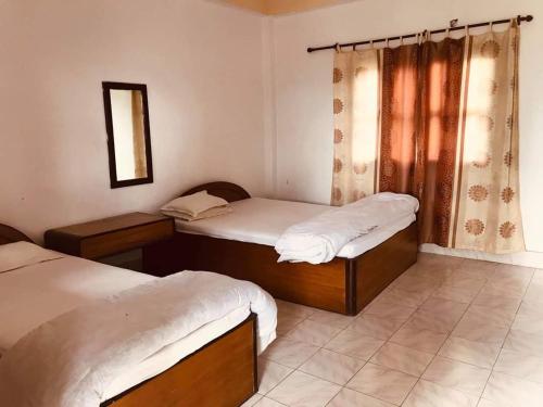 索拉哈Hotel Gainda Island Camp的一间卧室设有两张单人床和一面镜子