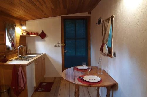 JaujacCharmante Roulotte atypique的一个带桌子和水槽的小厨房