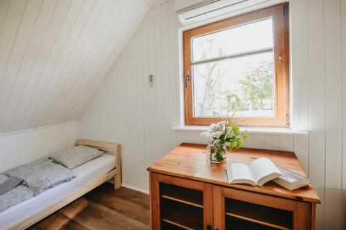 格丁尼亚Domki letniskowe Babie Doły的一间卧室配有床和一张带书籍的书桌