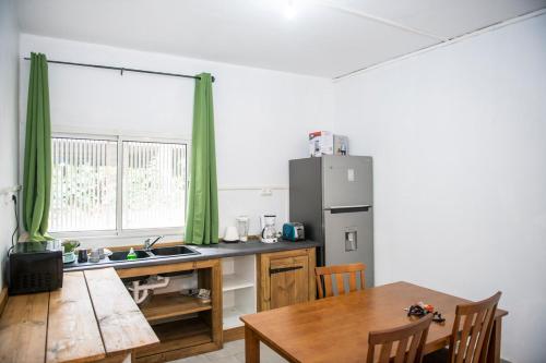 Mtsamgamoujiguest mtsangamouji F3的厨房配有木桌和冰箱。