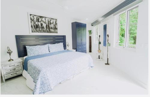 曼努埃尔安东尼奥Puerta Del Mar的卧室设有蓝色和白色的床和窗户。
