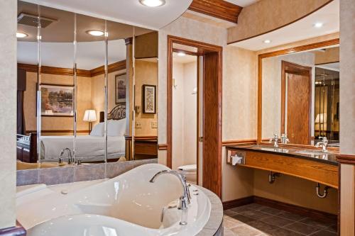 康沃尔林荫道旅馆及会议中心贝斯特韦斯特酒店的带浴缸的大浴室和卧室