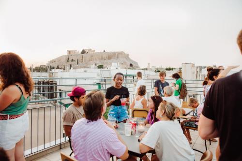 雅典雅典背包客旅舍的一群人坐在阳台上的桌子旁