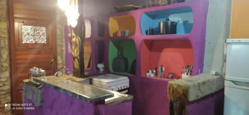 阿尔布斯Il Nuraghe的一个带水槽和紫色墙壁的厨房