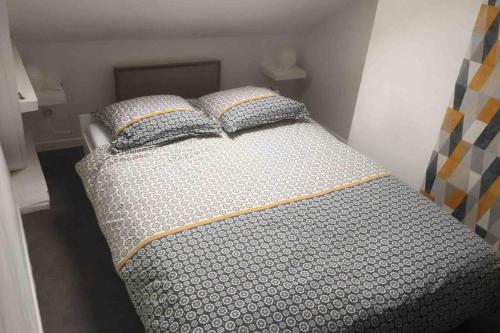 AnnoeullinAppart Cosy Annœullin - Proche toutes commodités的一张床上有两个枕头的房间