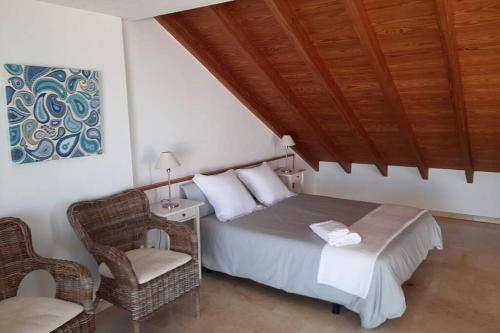 科洛尼亚圣霍尔迪S'Estel. Colònia de Sant Jordi. Mallorca的一间卧室配有一张床和一把椅子