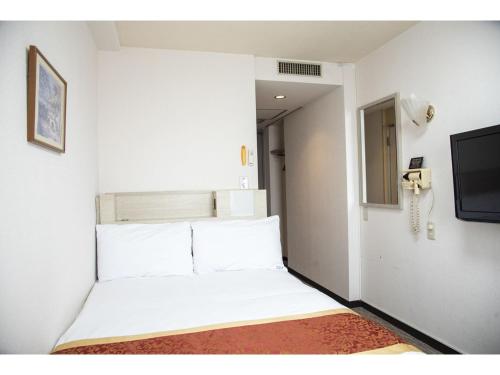 堺市Osaka Bay Plaza Hotel - Vacation STAY 44083v的带电视的客房内的一张白色床
