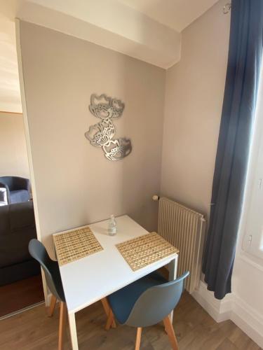 SeurreL’appartement de Rose的客房内的小白色桌子和椅子