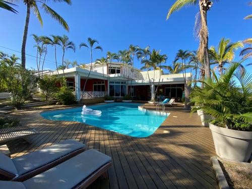 拉萨尔勒班Villa Prana的棕榈树屋前的游泳池