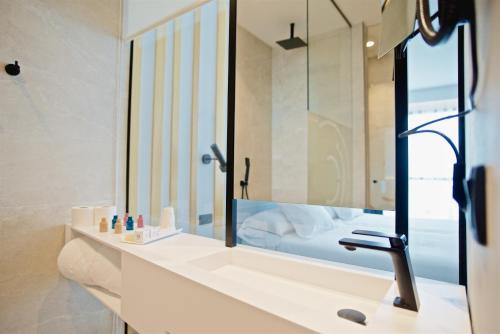 佩德雷尔Syncrosfera Fitness & Health Hotel Boutique的一间带水槽和镜子的浴室