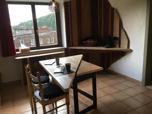 马尔梅迪Bois & Repos的带窗户的厨房里的桌椅
