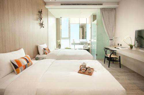 嘉义市承亿文旅-桃城茶样子的酒店客房配有两张床和一张书桌