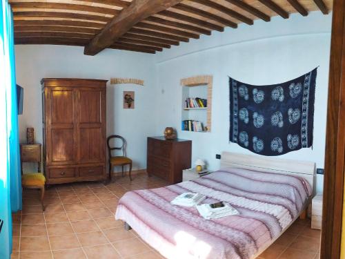锡耶纳Da Simone podere santi Lucia e Pietro的一间卧室配有一张带粉色毯子的大床