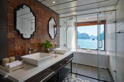 下龙湾Halong Capella Cruise的一间带两个水槽和玻璃淋浴间的浴室