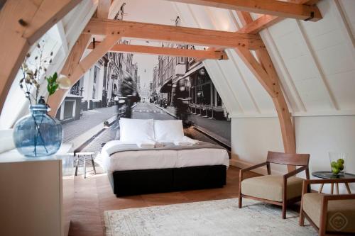 阿姆斯特丹阿姆斯特丹奈恩IX号酒店的卧室配有一张床,享有街道的景色