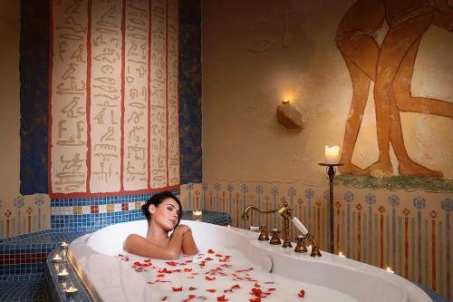 别尔斯克-比亚拉帕普加公园酒店康体加Spa的躺在玫瑰花瓣浴缸中的女人