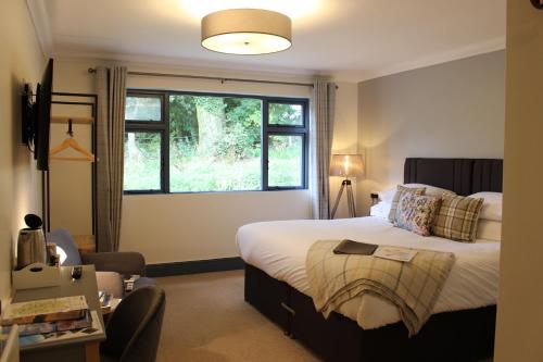 IrebyWoodlands Country House & Cottage的一间卧室设有一张大床和一个窗户。