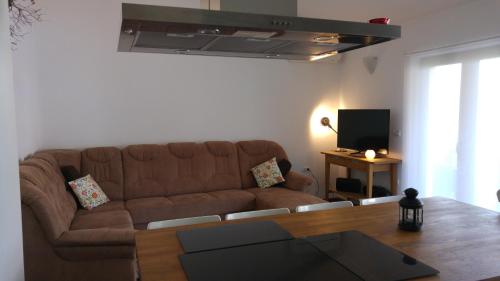 PobegiKmetija Jogan, Wines & Apartments的客厅配有棕色沙发和桌子
