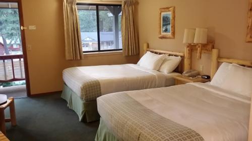 Twain Harte怀尔德伍德旅馆的酒店客房设有两张床和窗户。