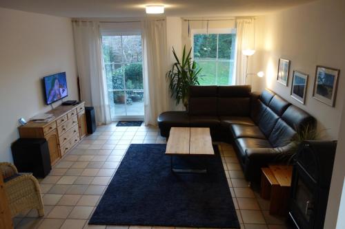 海利根港Haus Mehler的客厅配有真皮沙发和茶几