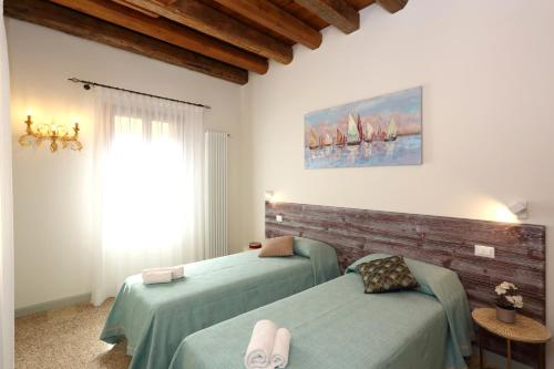 Ca' del Pittor Apartments客房内的一张或多张床位