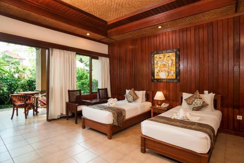 斯里法拉别墅度假酒店客房内的一张或多张床位