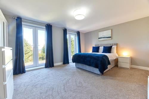 锡豪西斯Host & Stay - Castle View的一间卧室配有蓝色窗帘、一张床和窗户