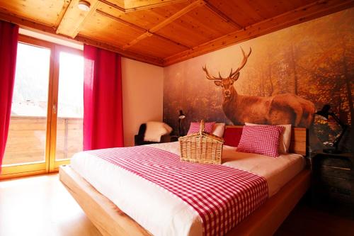 马尔尼茨Haus Waldruhe的卧室配有一张床,墙上挂着鹿